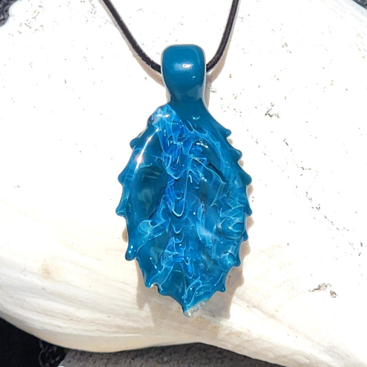 Ocean Drift Glass Pendant Necklace with textured blue-green glass and silver accents, handmade for ocean-inspired jewelry lovers.