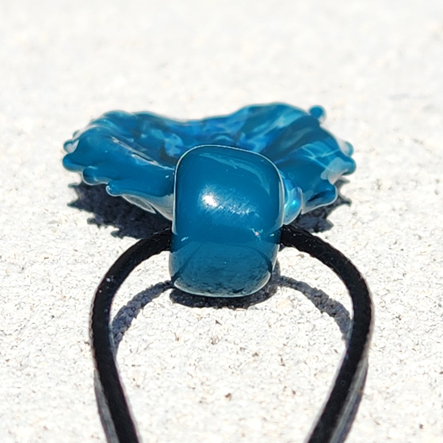 Close-up of Ocean Drift Glass Pendant Necklace bail and cord, showing smooth glass loop and durable black necklace cord.