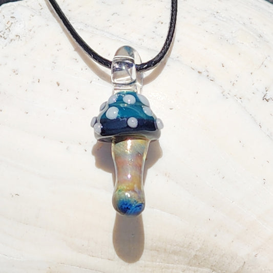 Blue Mushroom Art Glass Pendant with metallic stem and white polka dots on a black cord. Handmade mushroom necklace for boho jewelry lovers.