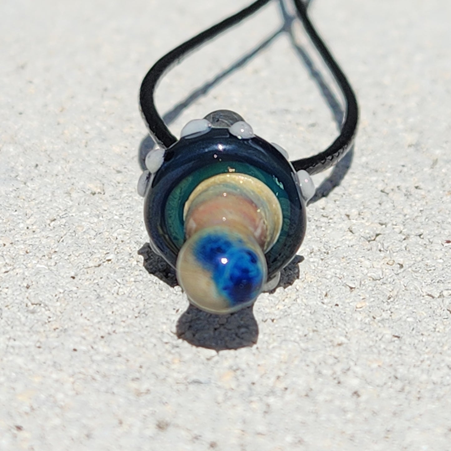 Bottom view of Blue Mushroom Glass Pendant showing the detailed stem design and black cord. Artistic handmade necklace for gift giving.