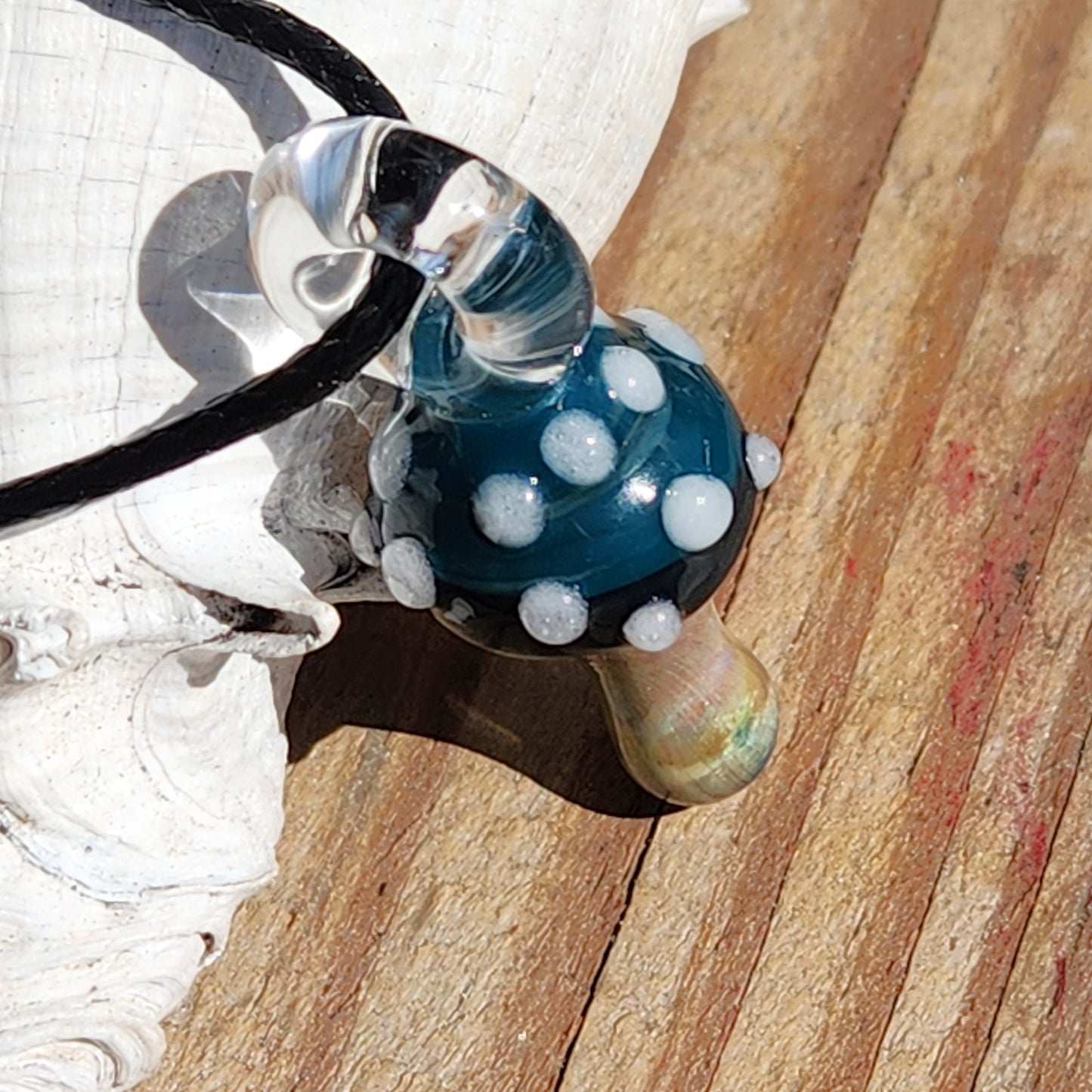 Handmade Blue Mushroom Glass Pendant Necklace featuring a glossy blue cap with white dots and iridescent stem, ideal for nature-inspired fashion.