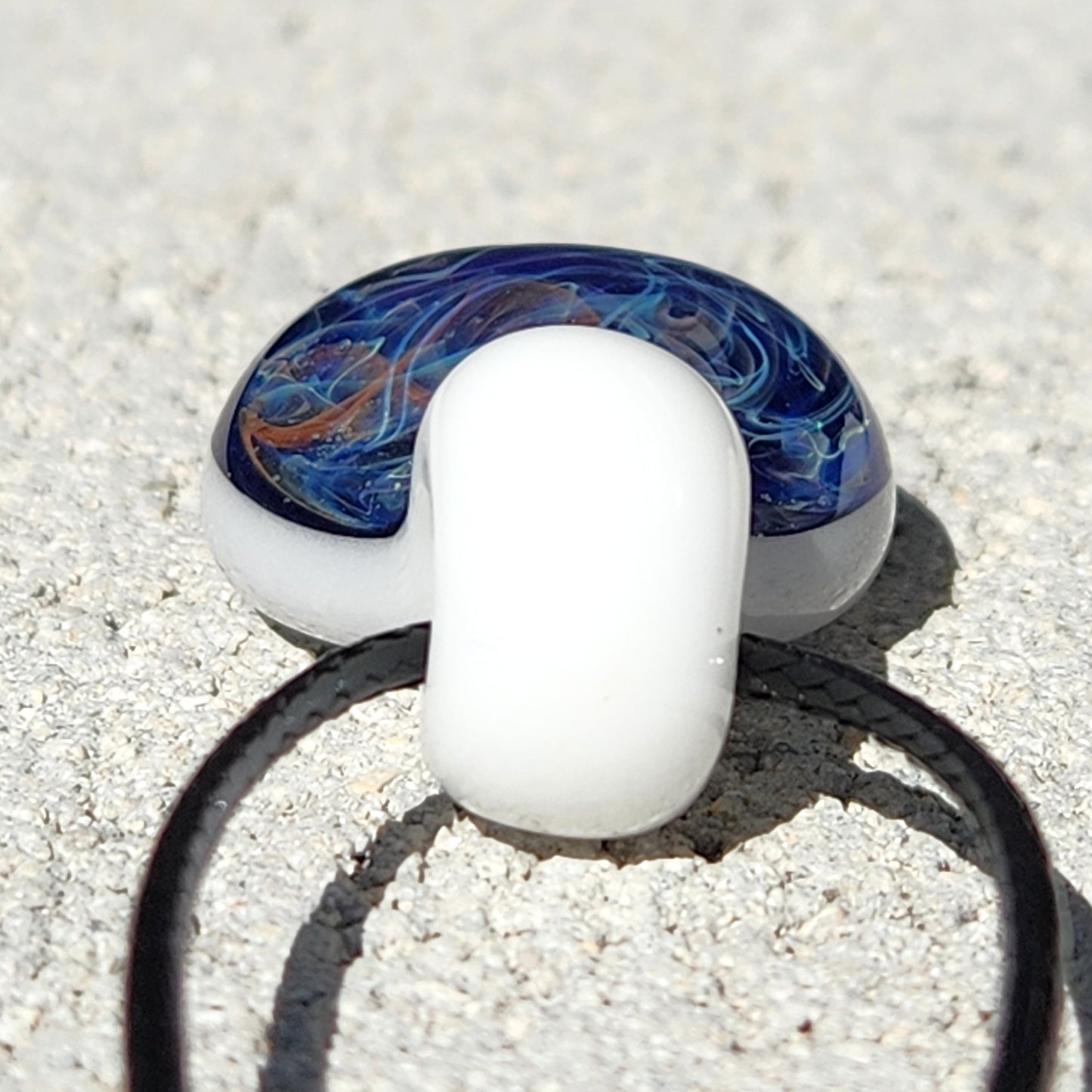 Back view of Deep Blue Galaxy Pendant Necklace showing smooth white glass loop and domed galaxy pendant, handmade and unique.