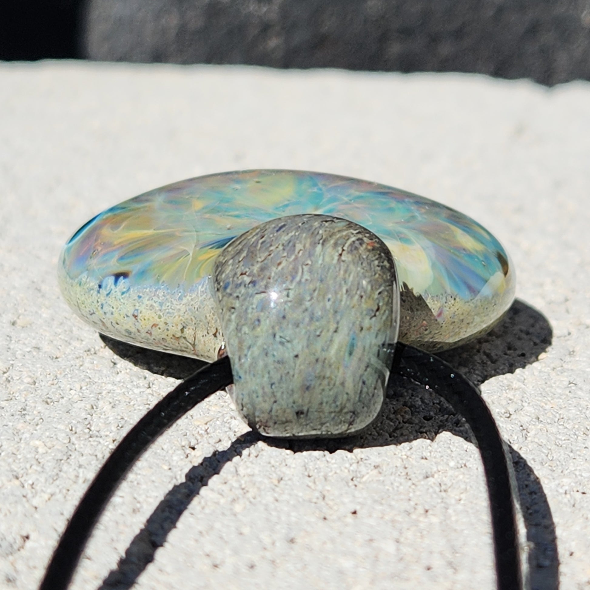 Bottom view of Handmade Glass Pendant Necklace showing its smooth, rounded finish and detailed glass craftsmanship. Unique jewelry gift.