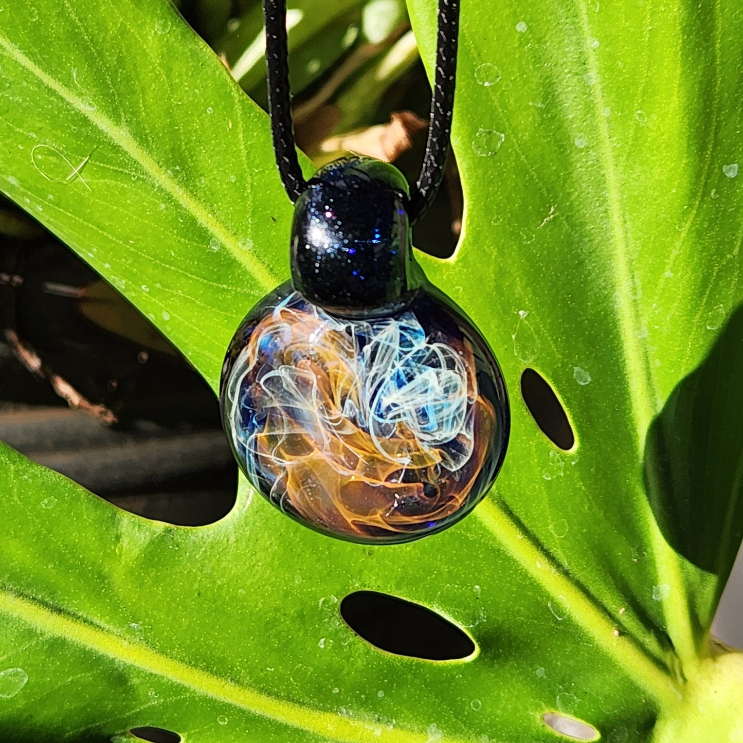 Gold & Silver Fumed Glass Pendant on Deep Blue Background