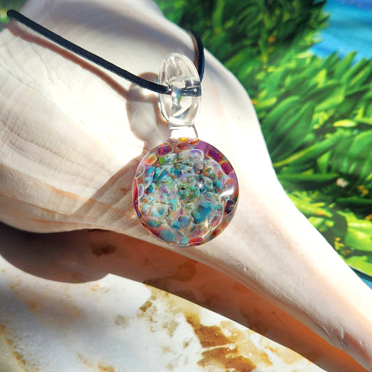 Ocean Reef Inspired Glass Pendant – Handmade Blown Glass Jewelry with vibrant reef colors, displayed on a seashell background.