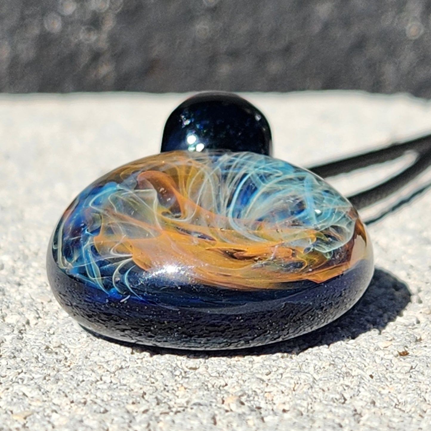 Gold & Silver Fumed Glass Pendant on Deep Blue Background