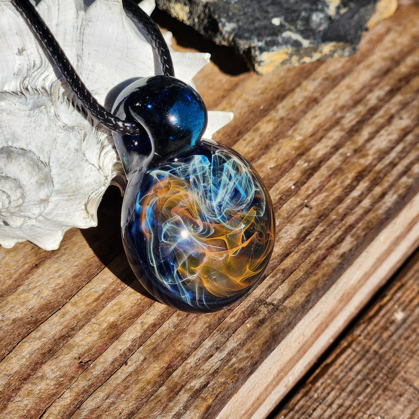 Gold & Silver Fumed Glass Pendant on Deep Blue Background