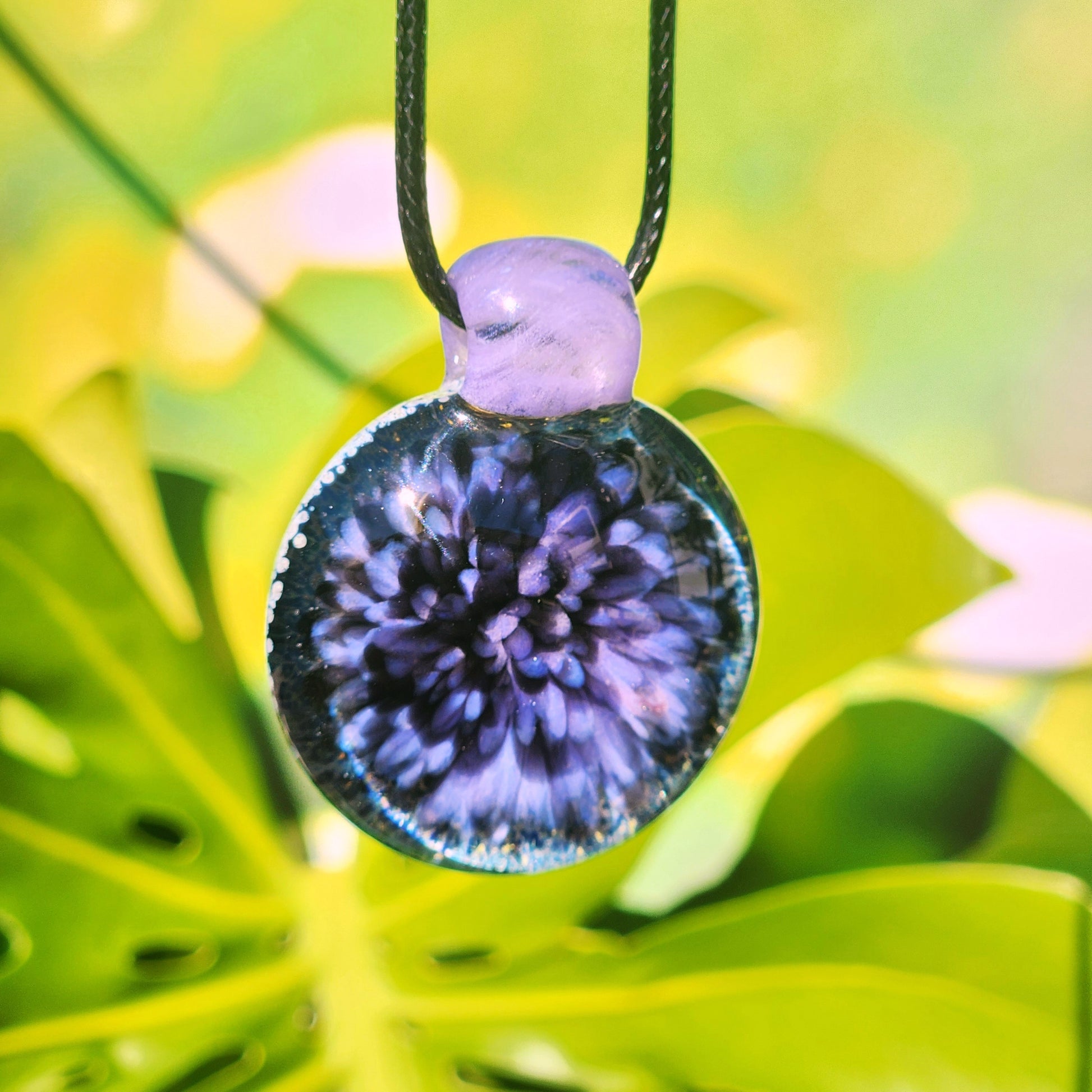 Purple Pink Borosilicate Glass Pendant Necklace on green leaves