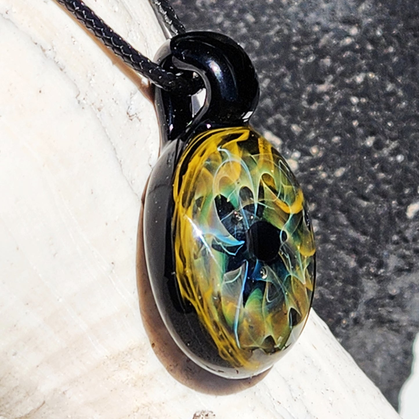 Unique handmade blown glass pendant necklace featuring a galaxy-inspired design in black, blue, and gold. Ideal glass jewelry gift for space lovers.