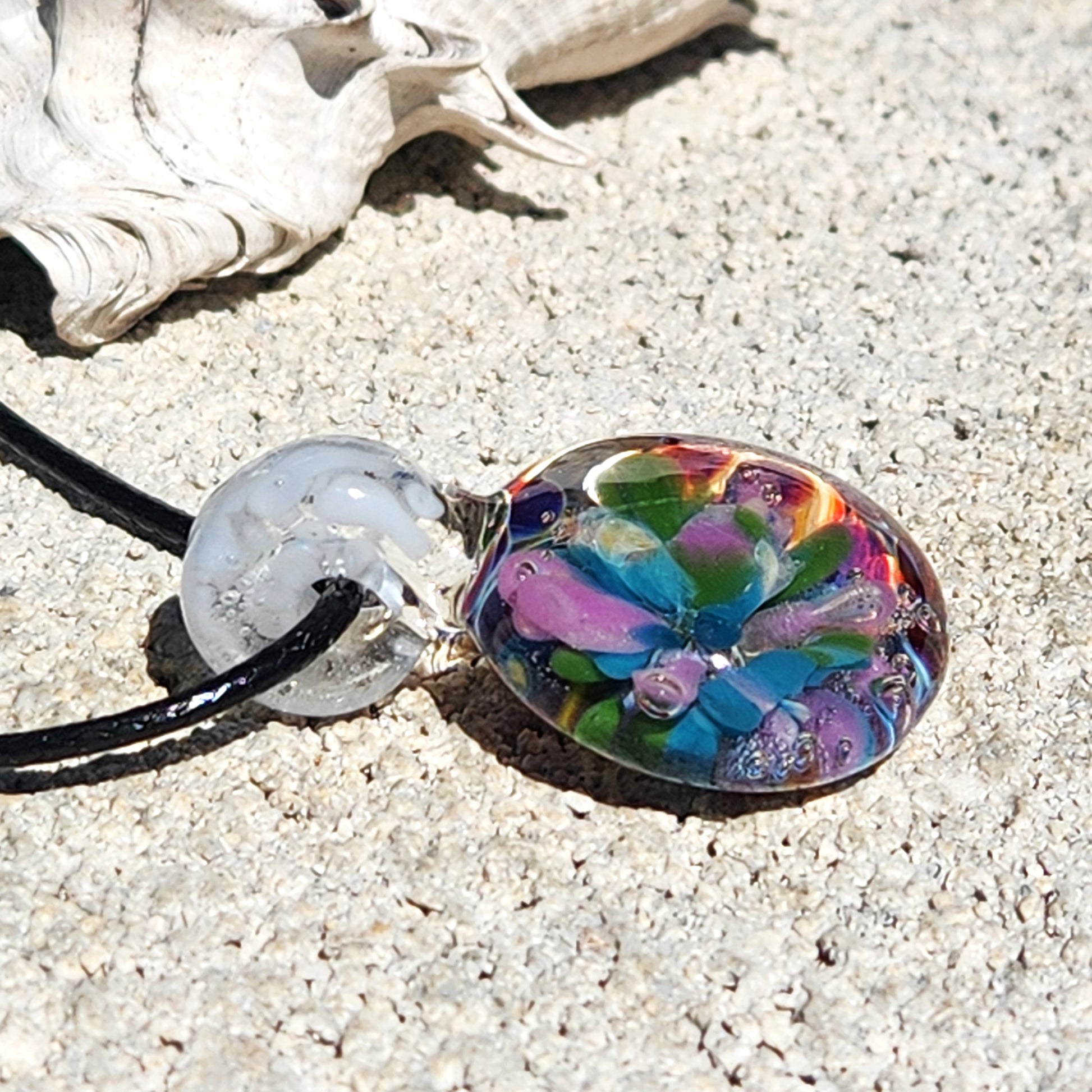 Unique purple glass pendant on black cord, artistic details