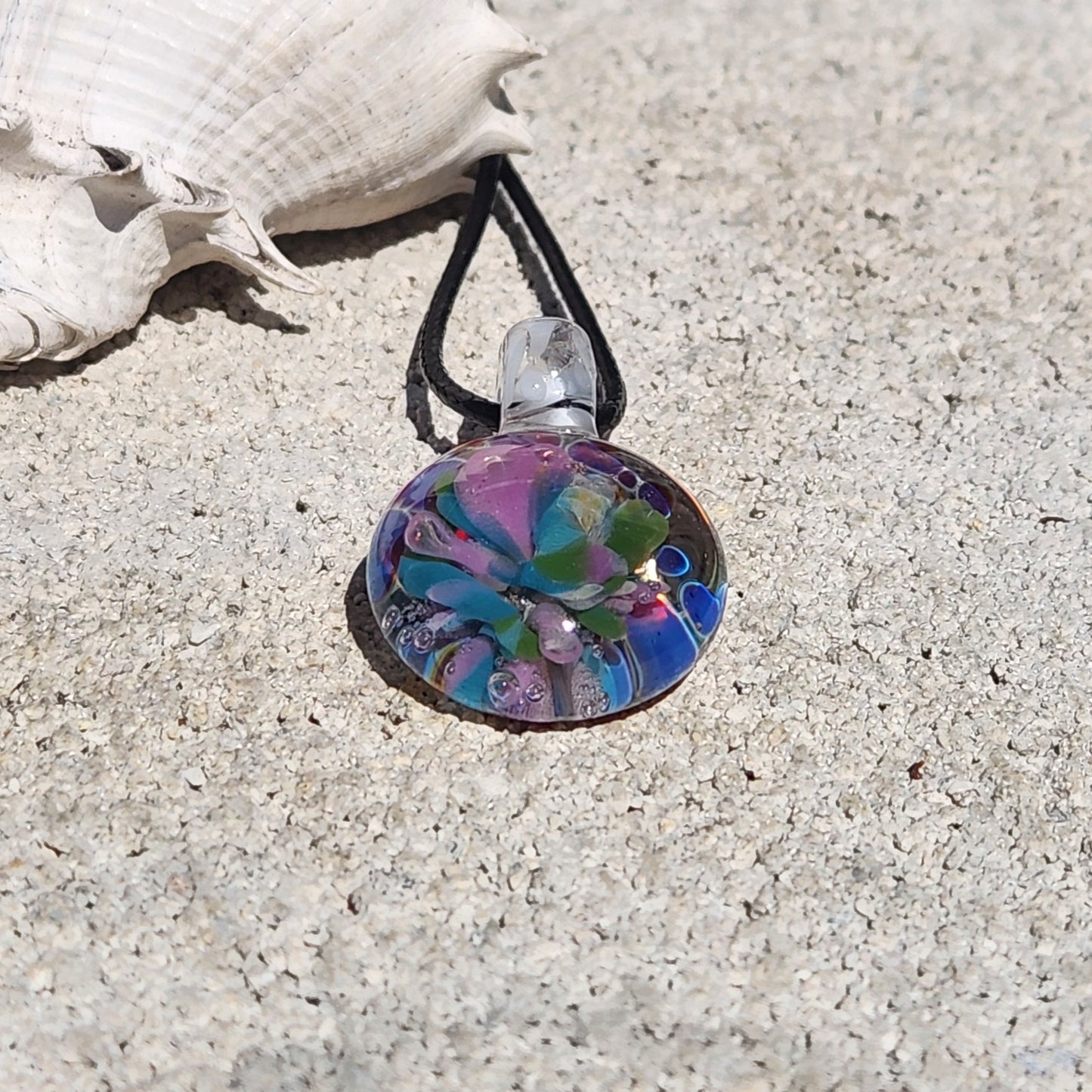 Colorful glass pendant necklace featuring floral patterns