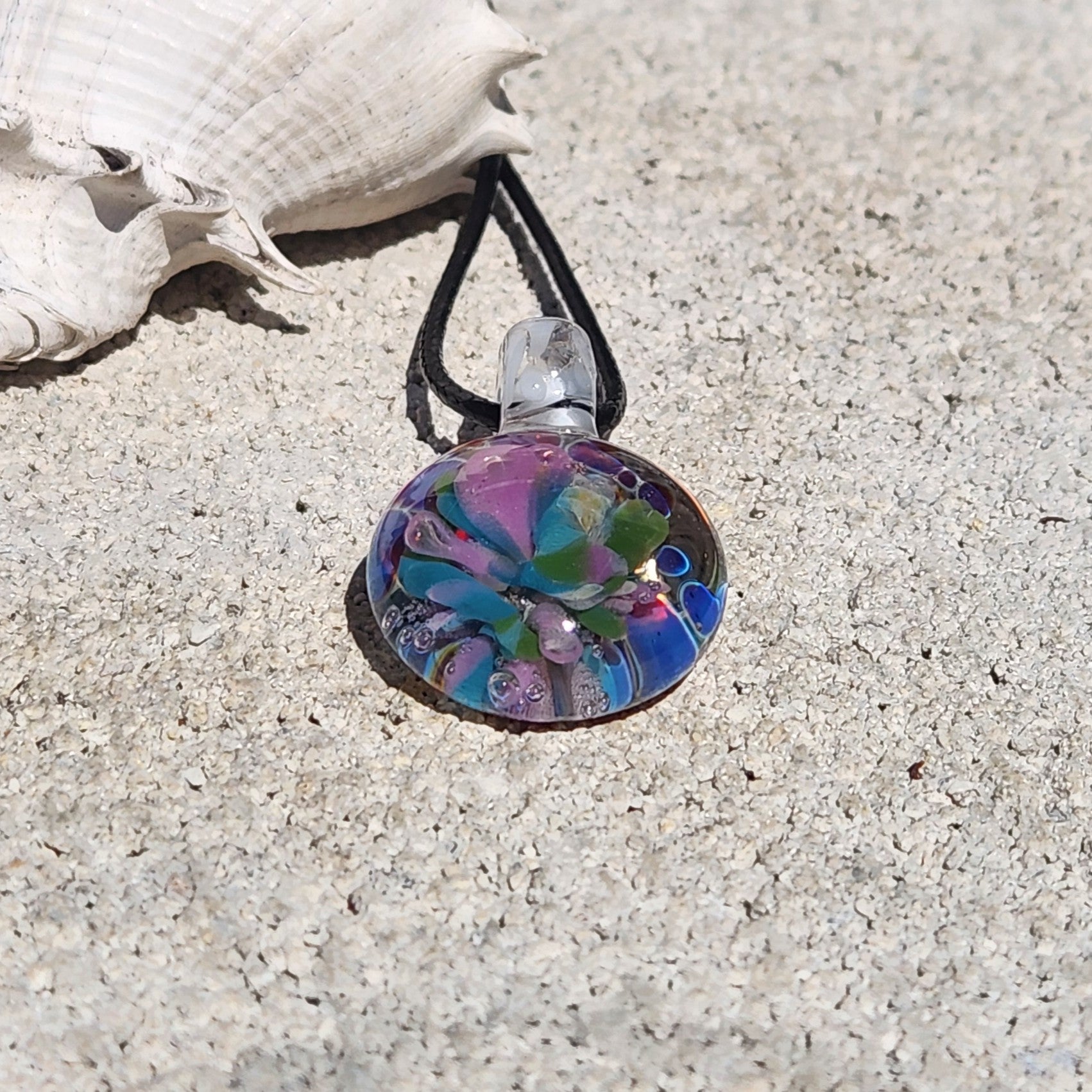 Colorful glass pendant necklace featuring floral patterns