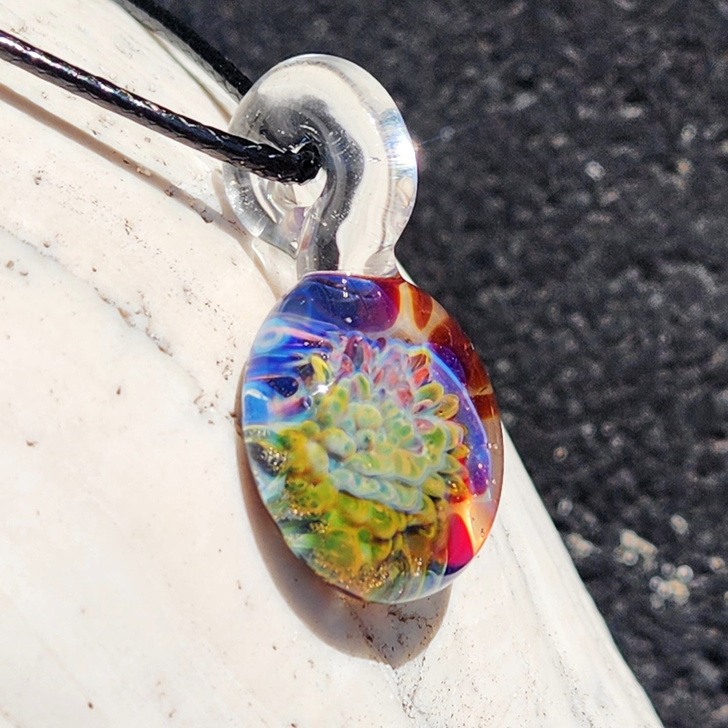 Colorful glass pendant necklace with intricate floral design, handmade jewelry