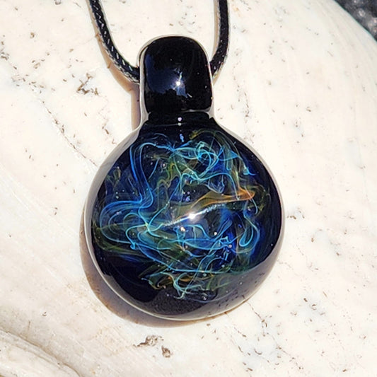 Necklace with a round pendant featuring blue and green designs on a white stone surface