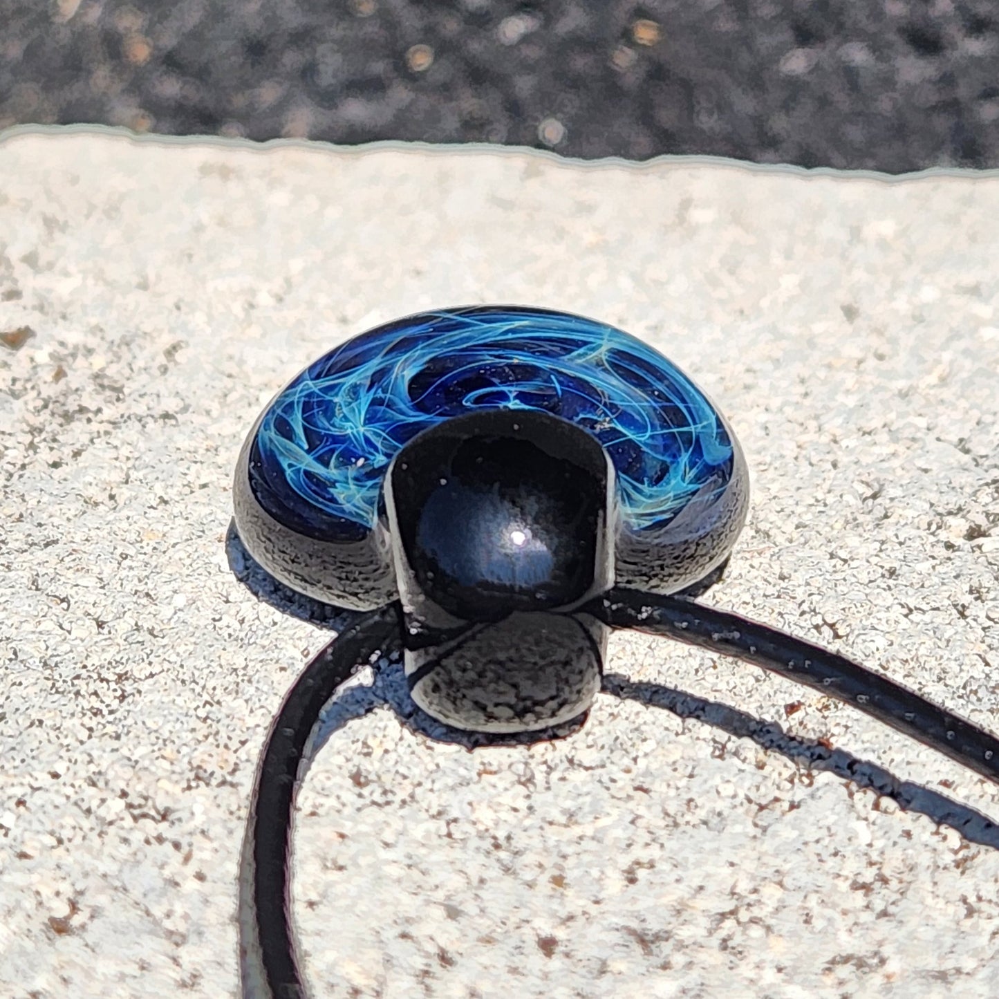 Blue electric swirl pattern on black glass pendant, handmade artisan jewelry on adjustable cord, gift boxed