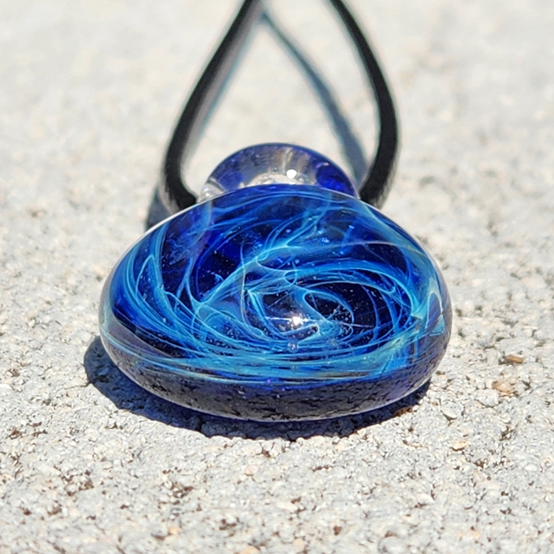 Handmade blue glass pendant with swirling galaxy patterns, small size, on adjustable cord, artisan jewelry, gift boxed