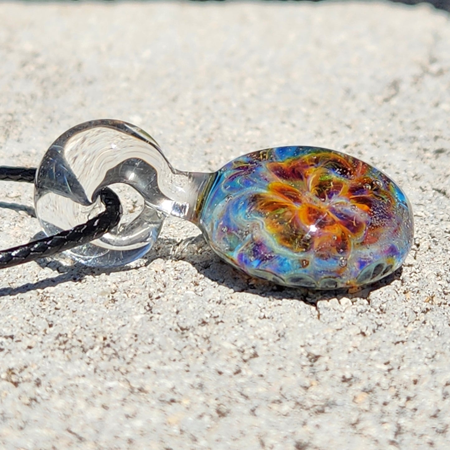 Detailed shot of the glass pendant's vibrant swirl pattern, highlighting the handmade craftsmanship, SKU: Maly 116
