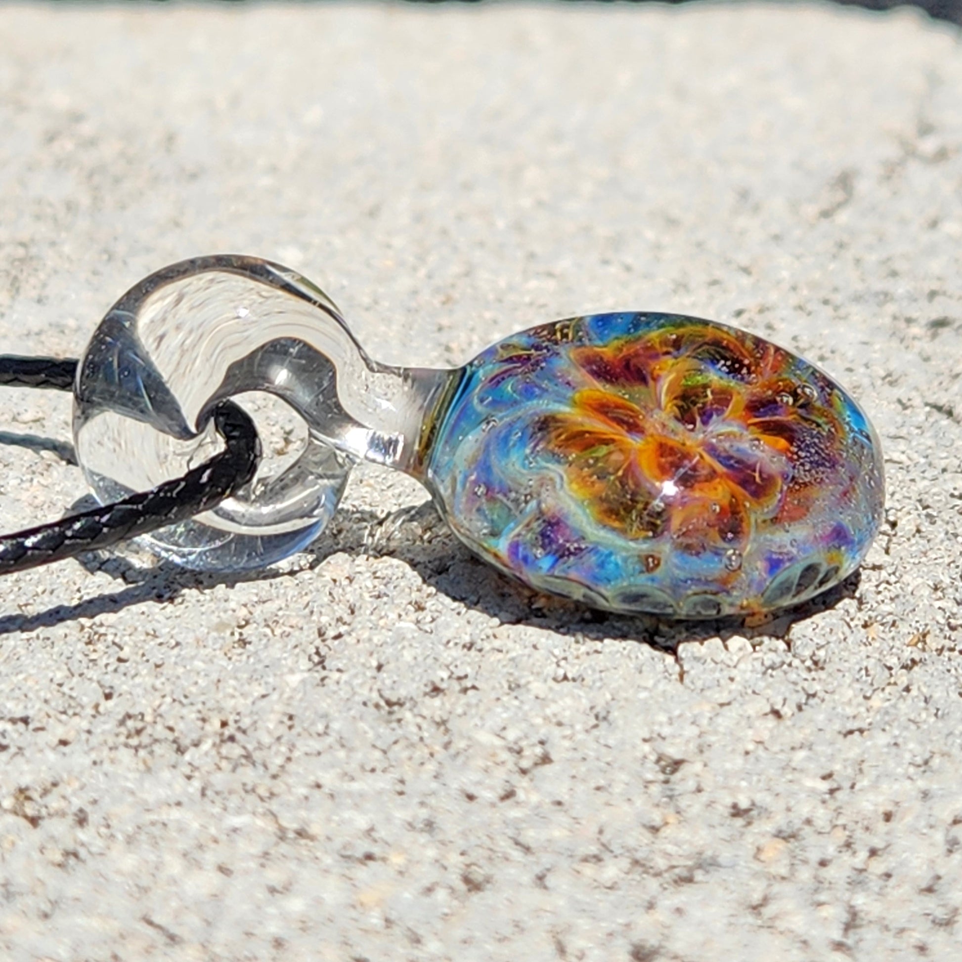 Detailed shot of the glass pendant's vibrant swirl pattern, highlighting the handmade craftsmanship, SKU: Maly 116