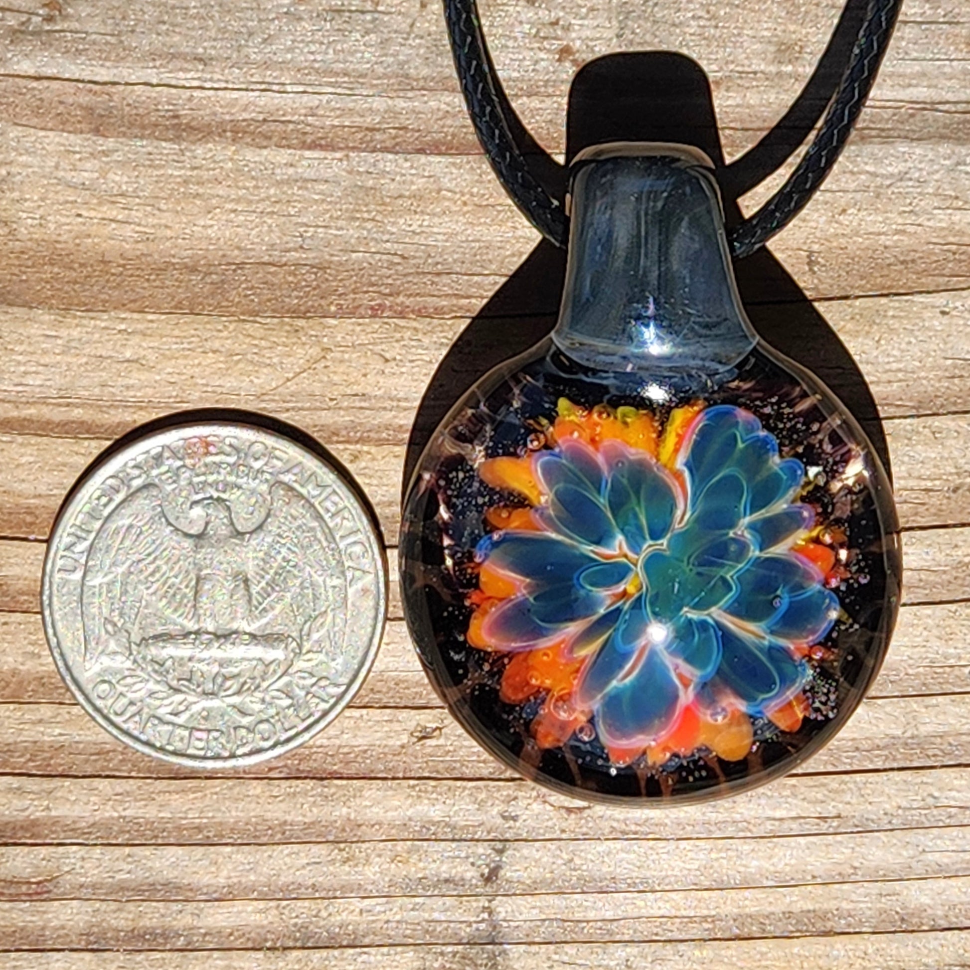 Front view of the handmade glass floral pendant necklace with black cord, showcasing vivid colors and intricate design.