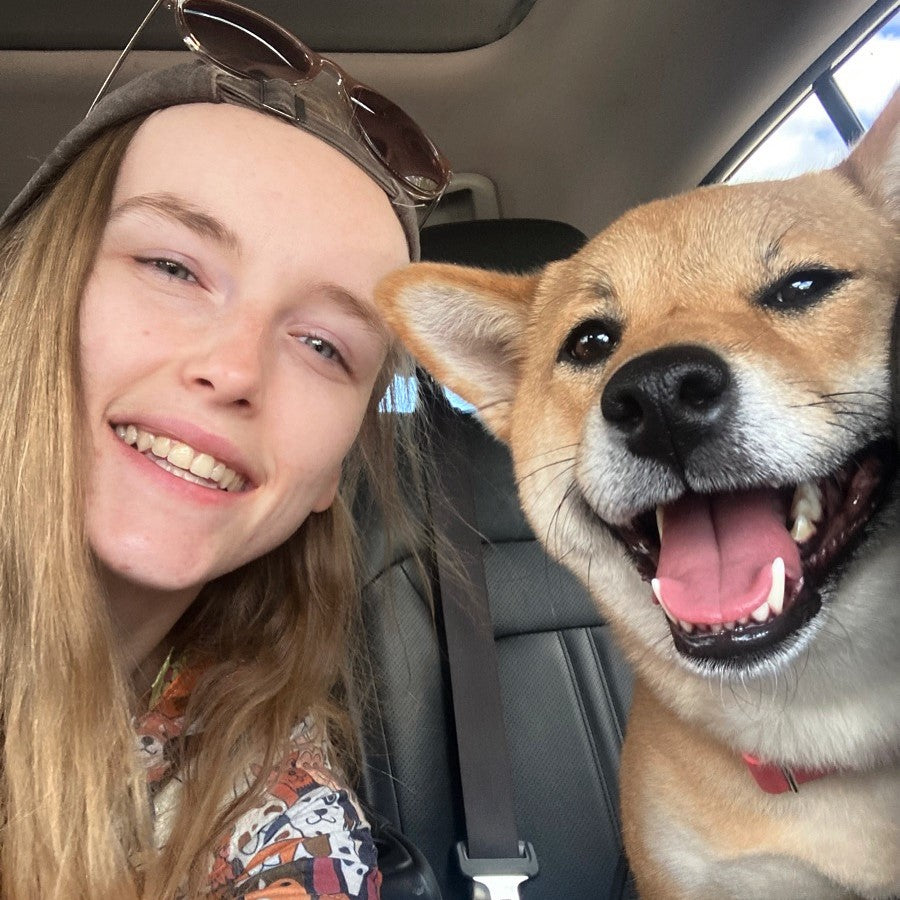 A picture of Lizzie with her dog Shiba Inu named Peaches