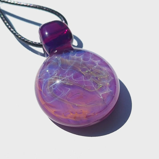 Purple glass pendant with silver and gold fuming detail, shown on white background. Bold handmade necklace with luminous finish.