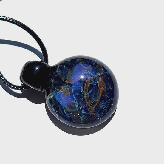 Handmade Glass Pendant – Unique Gold & Silver Fumed Black Necklace with deep blue and metallic swirls on white background.