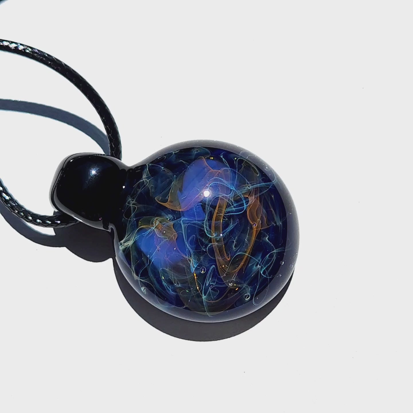 Handmade Glass Pendant – Unique Gold & Silver Fumed Black Necklace with deep blue and metallic swirls on white background.