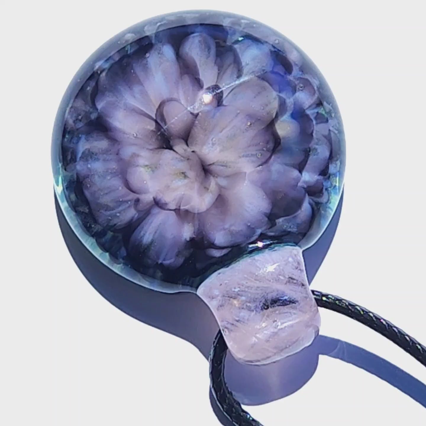 Handmade pink flower pendant necklace with crushed glass effect, casting a soft shadow on a white background for product display.