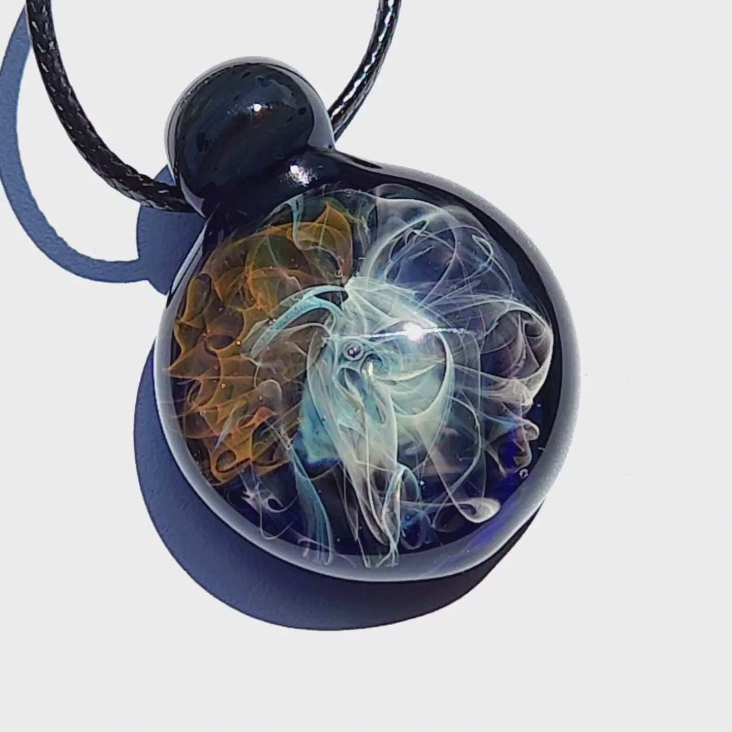 Close-up of Gold & Silver Fumed Glass Pendant Necklace highlighting galaxy-style implosion art. Artisan-crafted jewelry with vibrant color fusion.