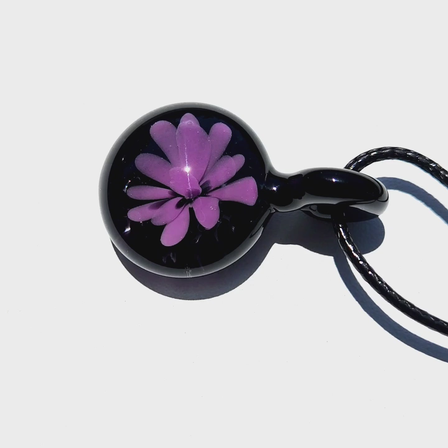 Minimalist purple flower glass pendant with glossy black finish, handmade in the USA, shown on white background for product clarity.